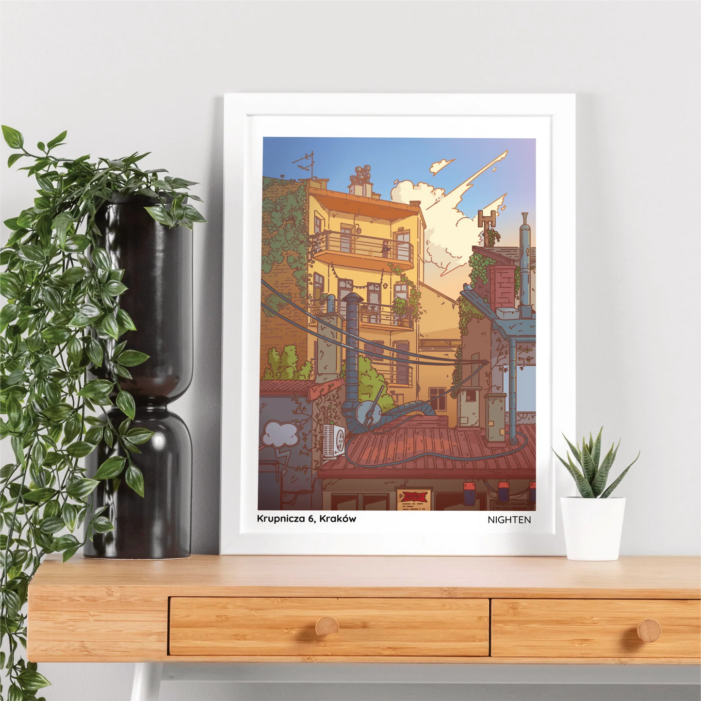 Framed artwork of a cityscape on a wooden shelf with plants