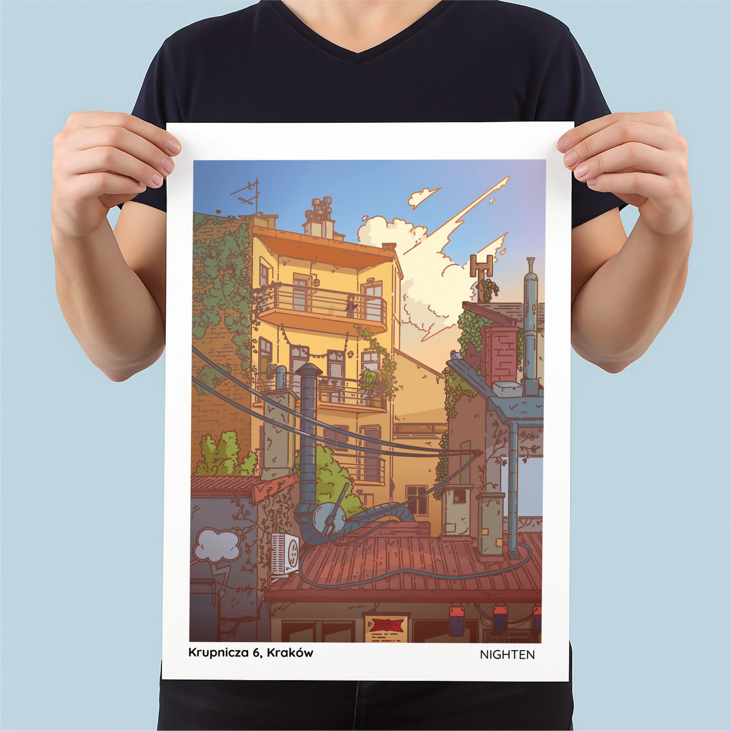 Person holding a poster of a cityscape with 'Krupnicza 6, Krakow' text.