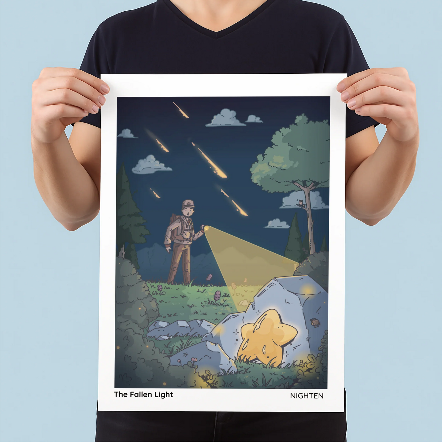 Person holding a poster of 'The Fallen Light' by Nighten with a starry night scene and a person with a flashlight.